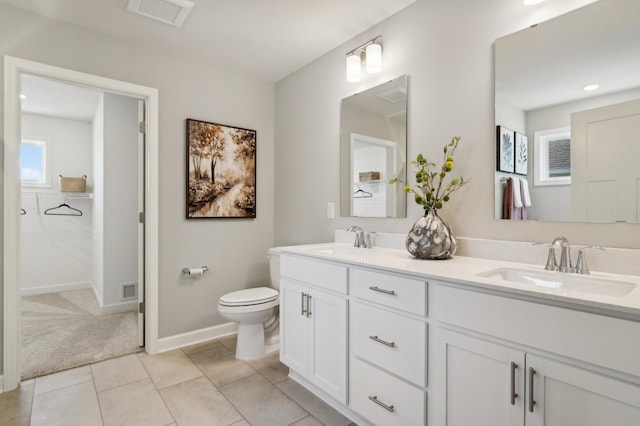 bathroom featuring tile patterned flooring, vanity, and toilet