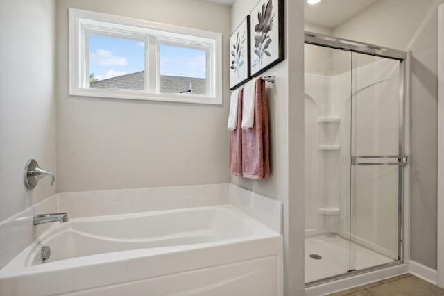 bathroom with tile patterned floors and separate shower and tub