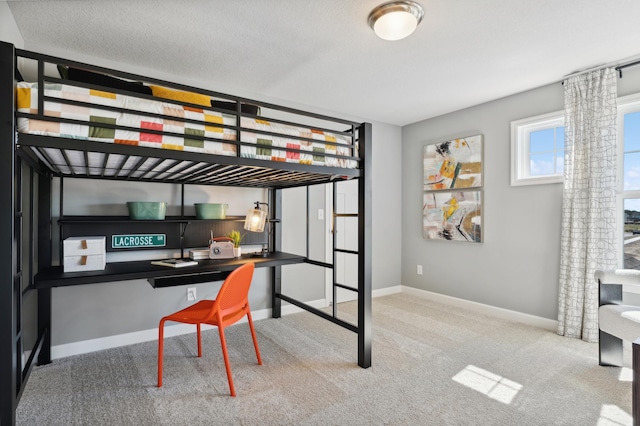 bedroom featuring light carpet and a textured ceiling