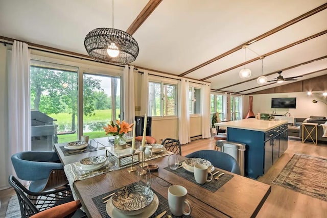 dining area with vaulted ceiling and light hardwood / wood-style flooring