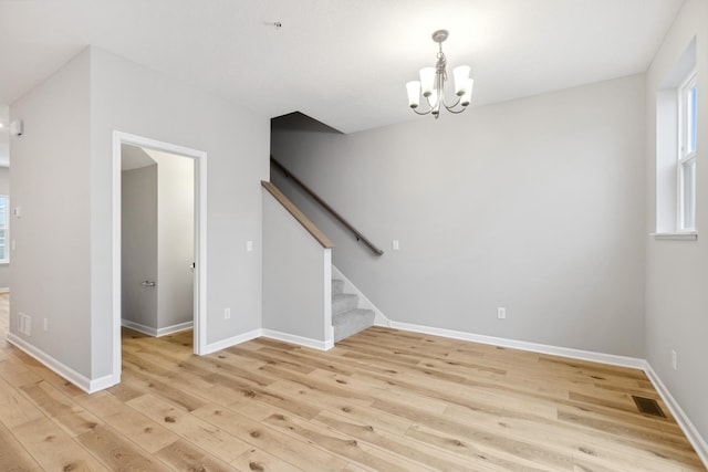 interior space with light hardwood / wood-style floors and a chandelier