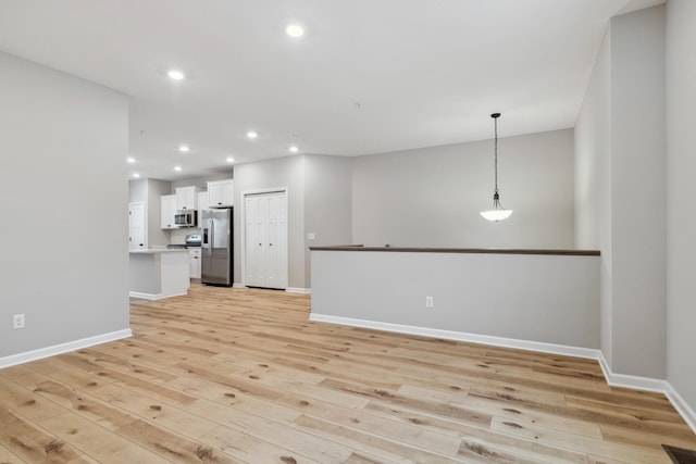 unfurnished living room with light wood-type flooring