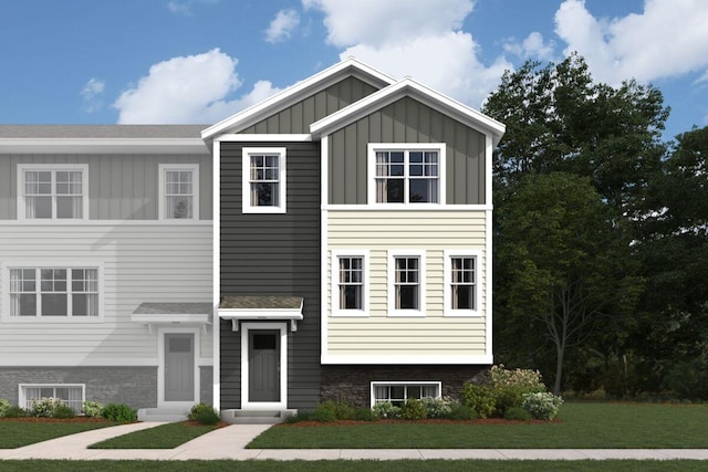 view of front of property with entry steps, a front lawn, and board and batten siding