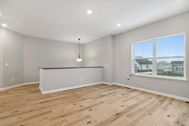 unfurnished room with light wood-style floors, baseboards, and recessed lighting