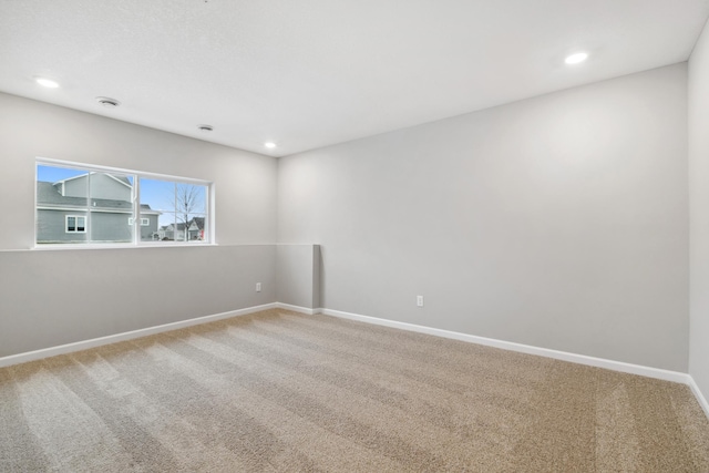 carpeted empty room with recessed lighting and baseboards