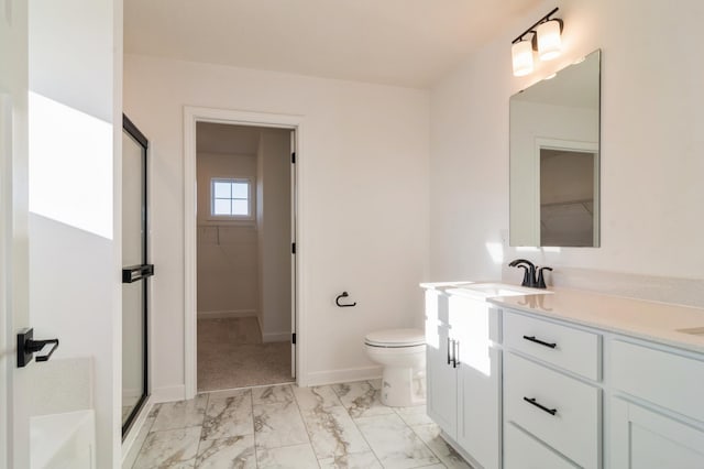 bathroom with vanity, toilet, and a shower with shower door