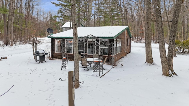 view of snow covered back of property