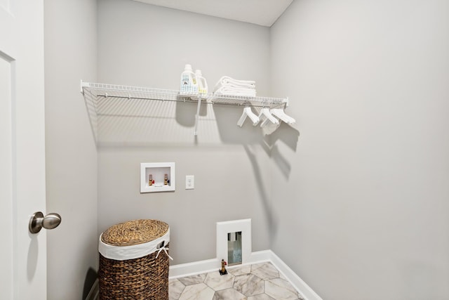 clothes washing area featuring baseboards, marble finish floor, hookup for a washing machine, and laundry area