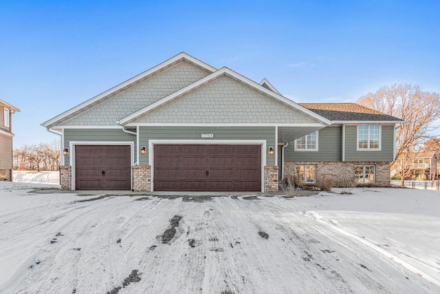 craftsman-style house with a garage and brick siding