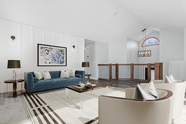 living room with an inviting chandelier and high vaulted ceiling