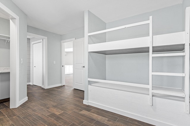 interior space with wood finish floors and baseboards