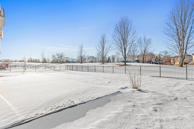 yard layered in snow with fence