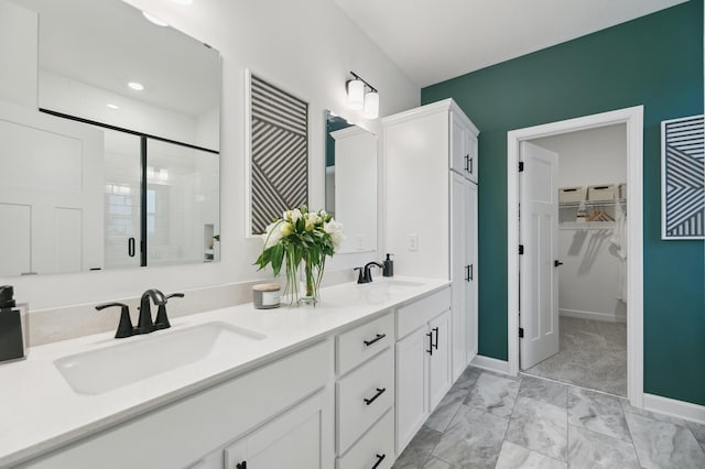 bathroom featuring vanity and a shower with shower door