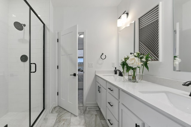 bathroom featuring vanity and an enclosed shower