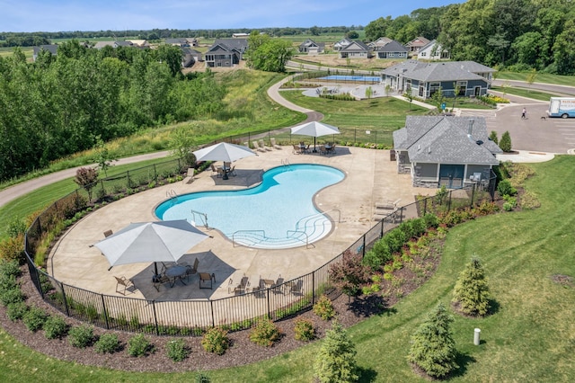 view of pool featuring a lawn and a patio area