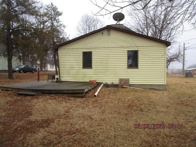 view of home's exterior with a wooden deck