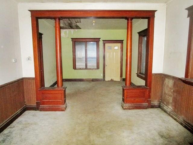 104 6th Ave E, Ellendale, MN 56026 - hall with a wainscoted wall, wooden walls, and carpet floors
