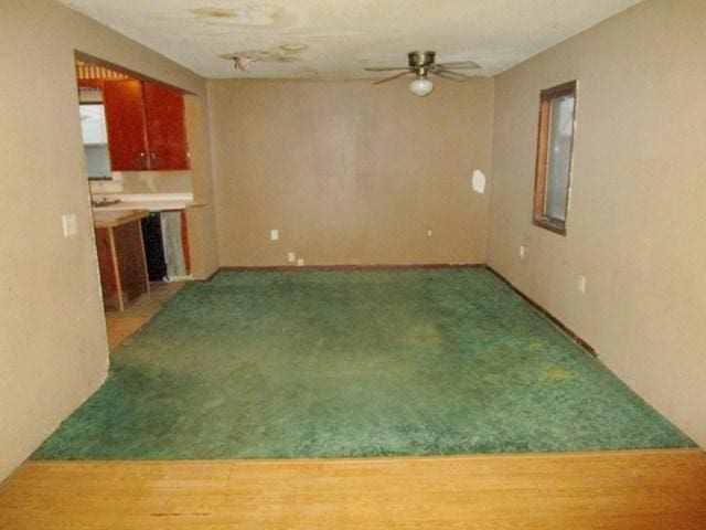 104 6th Ave E, Ellendale, MN 56026 - unfurnished living room featuring ceiling fan and carpet