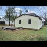 104 6th Ave E, Ellendale, MN 56026 - back of property with a lawn and a deck