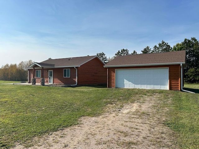 log home featuring an outbuilding, a garage, and a front lawn