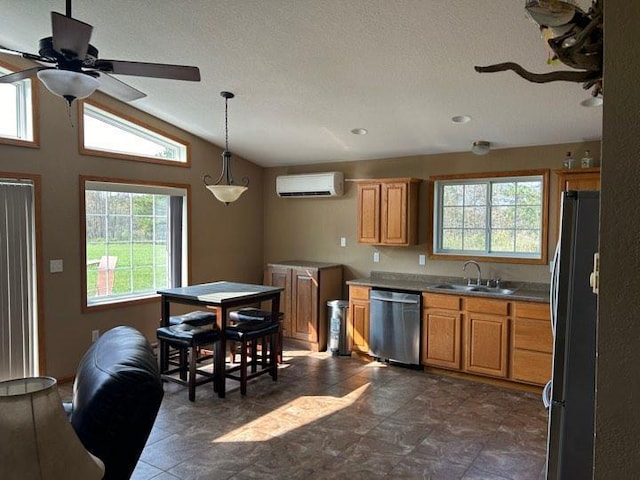 kitchen with pendant lighting, fridge, a wall mounted air conditioner, vaulted ceiling, and stainless steel dishwasher