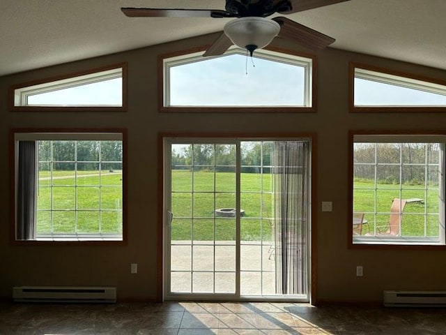 doorway to outside featuring a baseboard heating unit and a wealth of natural light