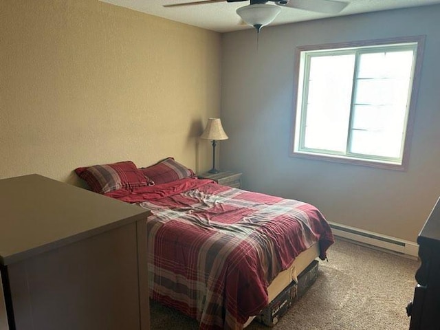 bedroom with carpet floors, ceiling fan, and baseboard heating