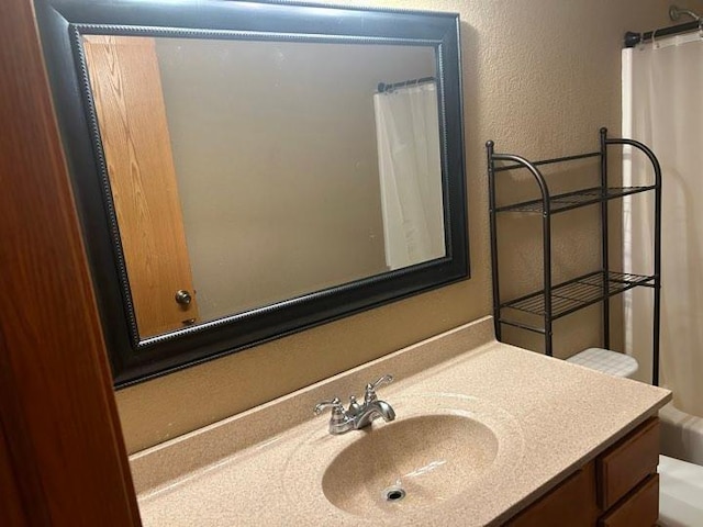 bathroom with vanity, toilet, and a shower with shower curtain