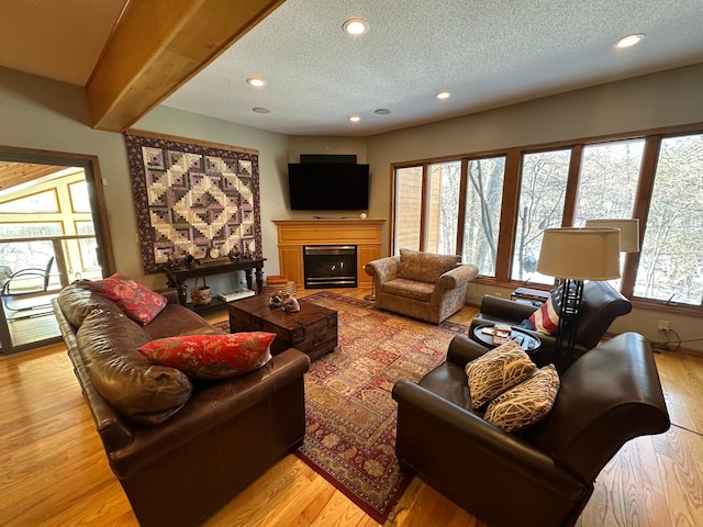 living room with light wood-type flooring and a textured ceiling