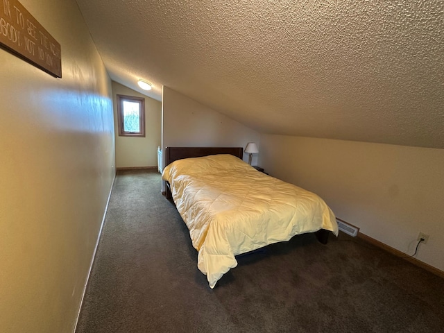 bedroom featuring a textured ceiling, vaulted ceiling, baseboards, visible vents, and carpet floors