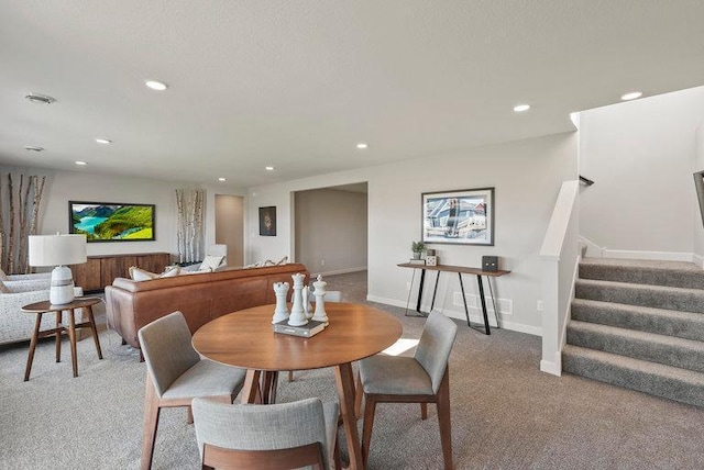 dining space featuring light carpet