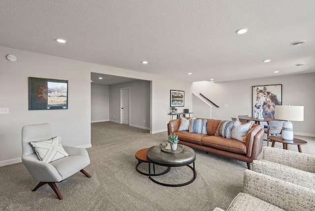 living room with carpet flooring and a textured ceiling