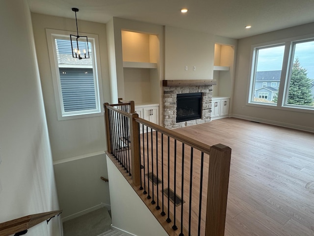 14514 Kingsview Ln, Dayton, MN 55327 - staircase with baseboards, built in features, wood finished floors, and a fireplace