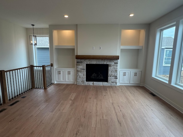 14514 Kingsview Ln, Dayton, MN 55327 - unfurnished living room with light wood finished floors, a fireplace, built in shelves, recessed lighting, and baseboards