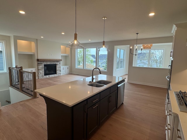 14514 Kingsview Ln, Dayton, MN 55327 - kitchen featuring stainless steel dishwasher, a sink, wood finished floors, and light countertops