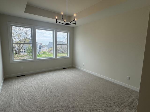 14514 Kingsview Ln, Dayton, MN 55327 - unfurnished room featuring baseboards, a raised ceiling, and a notable chandelier