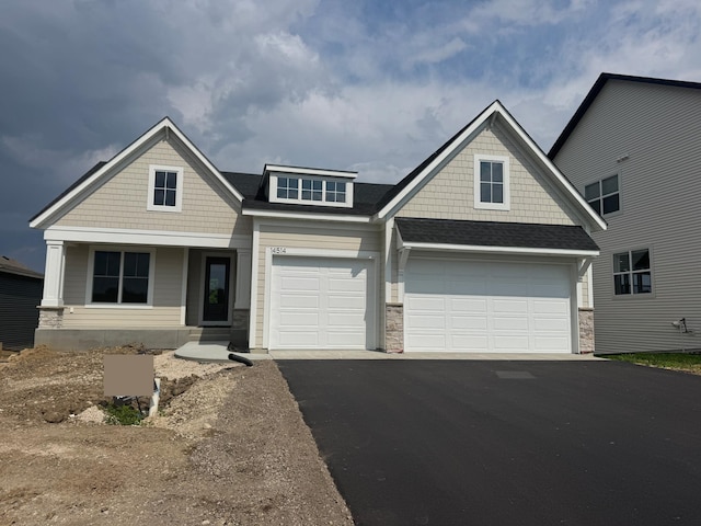 14514 Kingsview Ln, Dayton, MN 55327 - craftsman-style house with asphalt driveway, stone siding, a shingled roof, and a garage