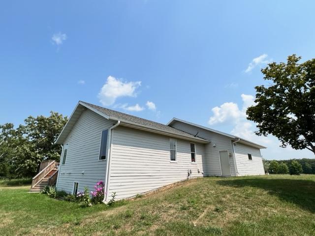 view of side of home with a yard