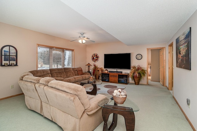 carpeted living room featuring a textured ceiling and ceiling fan