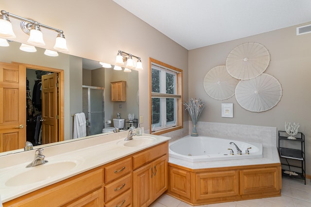 full bathroom with shower with separate bathtub, toilet, tile patterned floors, and vanity