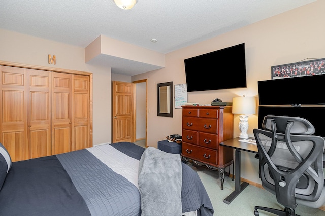 carpeted bedroom featuring a closet and a textured ceiling