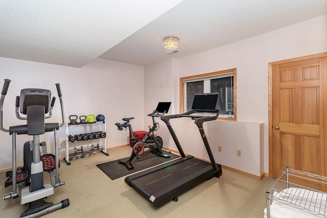 workout area featuring carpet floors and a textured ceiling