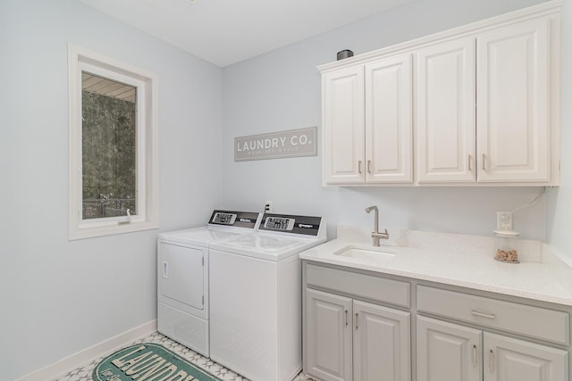 washroom featuring cabinets, sink, and independent washer and dryer