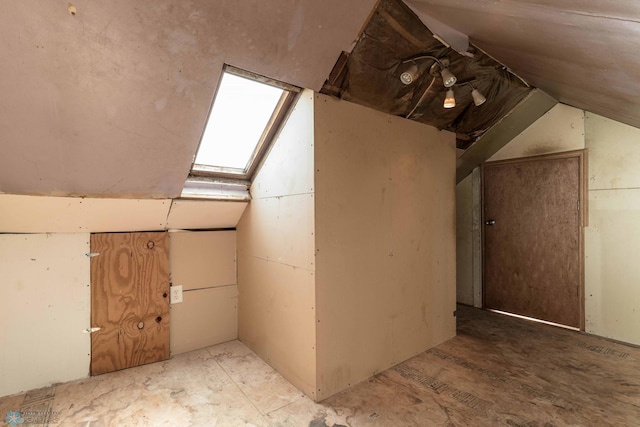 bonus room featuring lofted ceiling with skylight