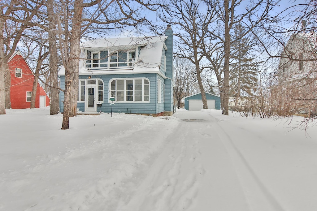 front of property featuring a garage and an outbuilding