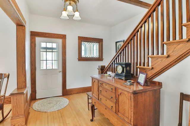 foyer entrance featuring a chandelier and light wood-type flooring