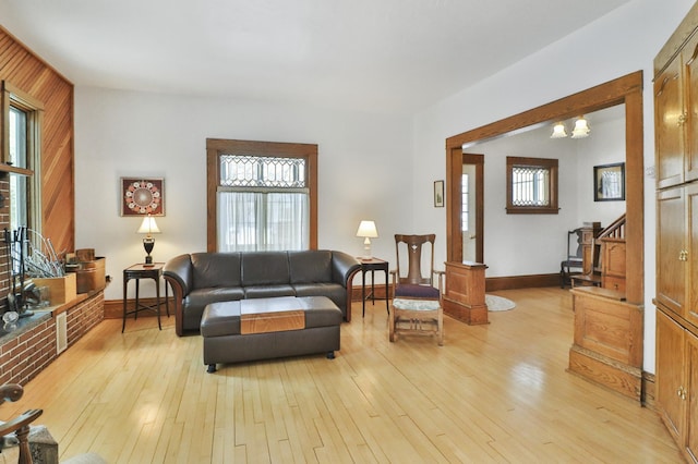 living room with light hardwood / wood-style floors and a chandelier