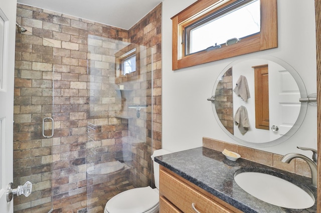 bathroom with vanity, toilet, and an enclosed shower