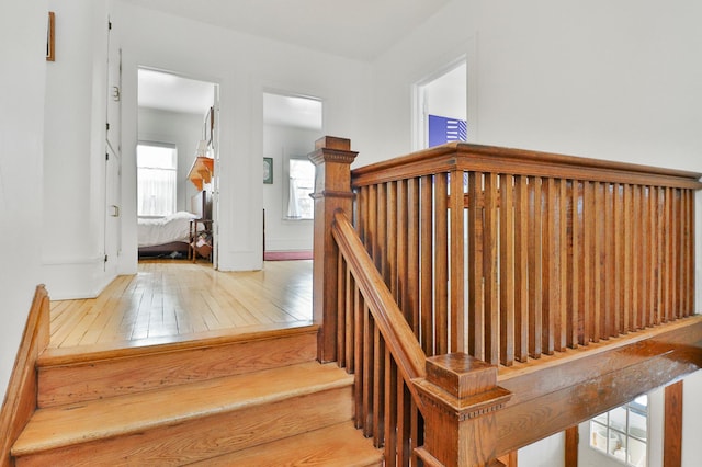 stairs with hardwood / wood-style floors