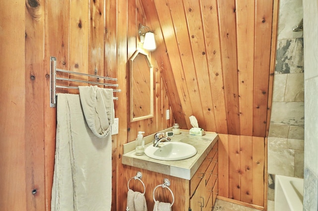 bathroom with vanity and wooden walls